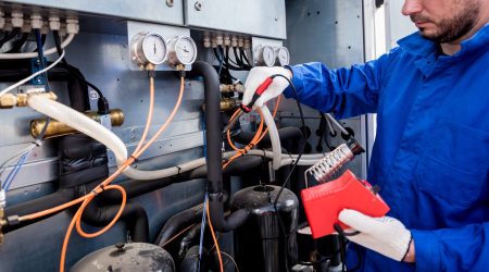 Technician from AOF Industries repairing electronic temperature sensor